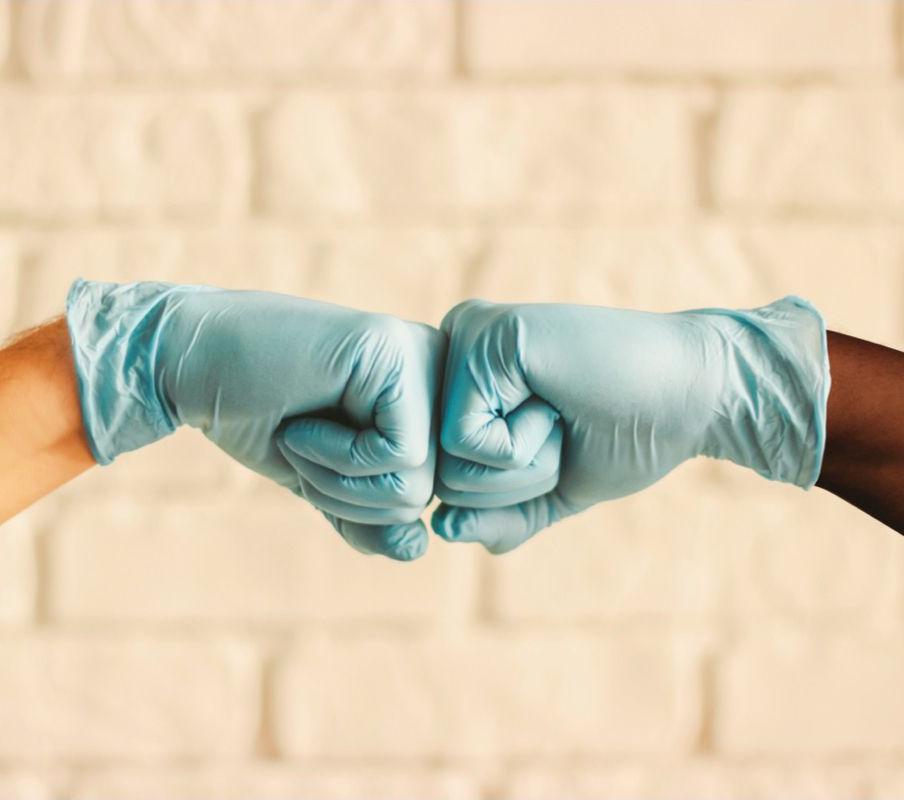 Two hard working Northeast Foods employees fist bumping.